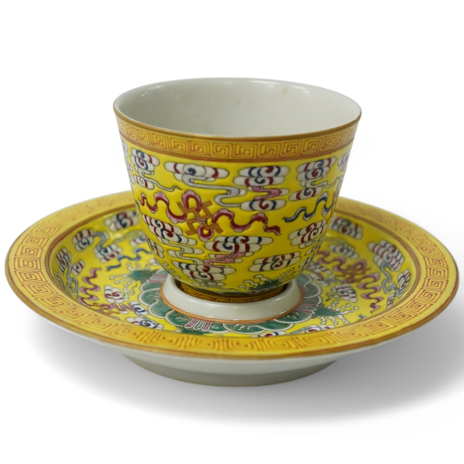A Chinese porcelain yellow-ground tea cup and saucer, 13cm diameter. Condition - good